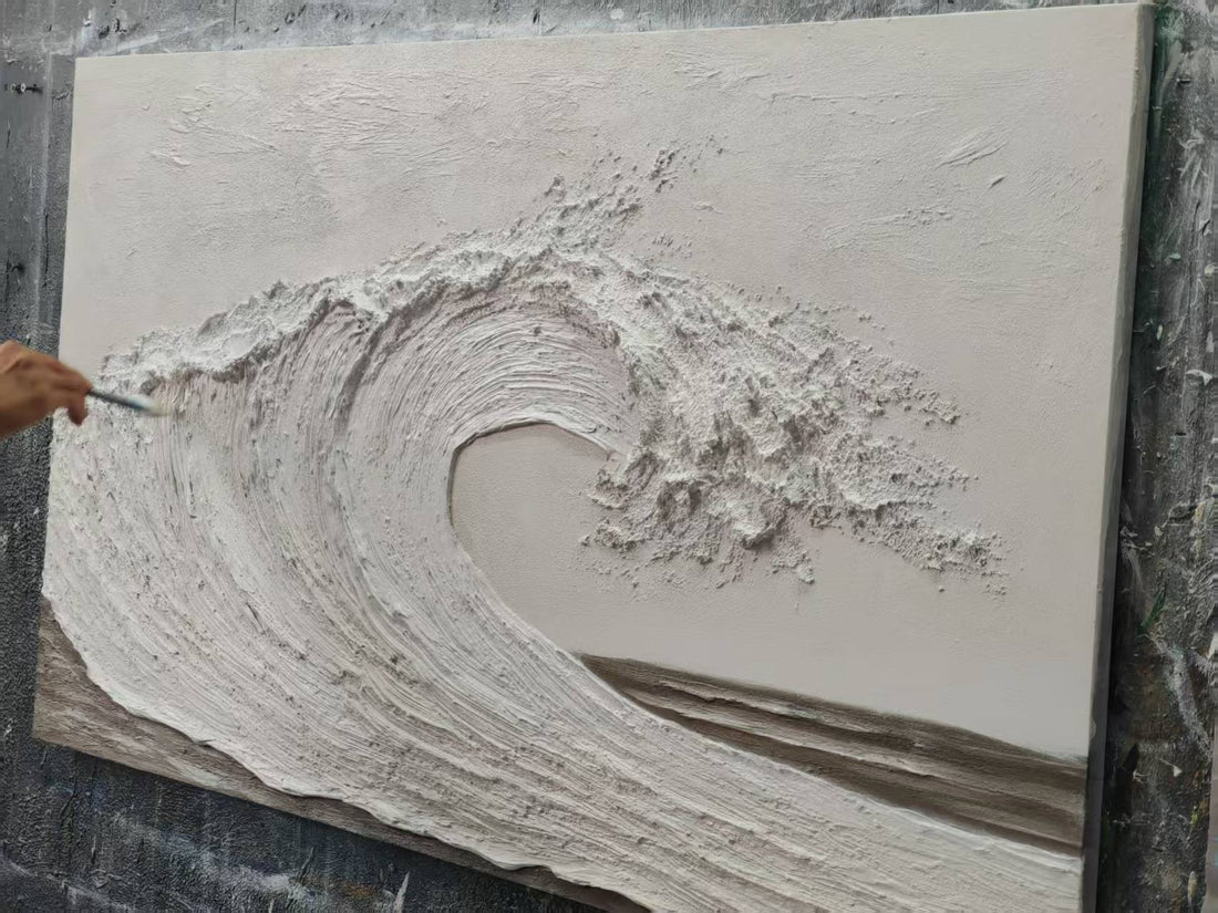 The artist is hand-painting