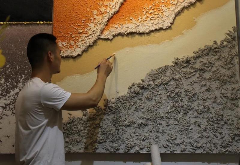 The illustrator is creating hand-drawn artwork